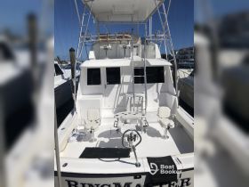 A clean and spacious helm area of the 'Bingmaster' boat, featuring seating and a console, ideal for fishing or cruising adventures.