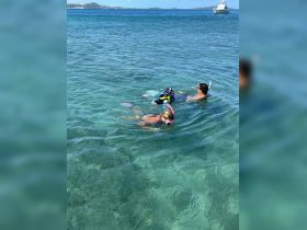 A family enjoys snorkeling in crystal-clear waters, creating unforgettable memories while exploring the underwater world.