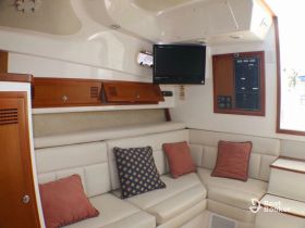 Interior view of a cozy boat cabin featuring comfortable seating and modern amenities, perfect for relaxing during your nautical adventures.