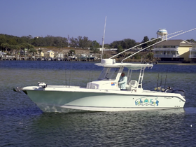 A fishing boat named 'Fish on Fun' navigates through calm waters, showcasing its sleek design and fishing gear — perfect for an adventurous day on the water.