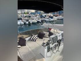 A cozy interior view of a boat's helm and seating area, featuring plush cushions and modern navigation equipment, perfect for relaxing on the water.