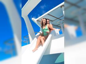 Two friends enjoy a thrilling moment on a water slide, showcasing the fun and excitement of a day on the water.