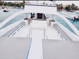 Interior view of a spacious boat cabin featuring comfortable seating and a clean design, perfect for relaxing during a day on the water.