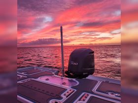 A stunning sunset view from a boat, showcasing the vibrant colors reflecting off the water, perfect for serene evening cruises.