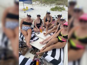 A fun group of friends relaxes on a boat, enjoying the sun and each other's company — perfect for a day of celebration on the water.