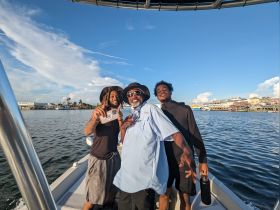 A joyful group of friends poses for a photo on a boat, capturing the essence of a fun day on the water. Perfect for showcasing memorable boating experiences.