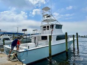 A person prepares a fishing boat at the dock, showcasing the excitement of getting ready for a day on the water.