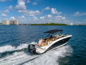 A lively group enjoys a thrilling ride on a sleek boat, showcasing the excitement of a day on the water with friends.