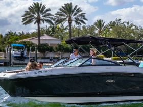 A lively group enjoys a day on the water aboard a sleek boat, capturing the essence of fun and adventure in a beautiful setting.