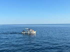 A lively group enjoys a day on the water aboard a boat, showcasing the perfect setting for fun and relaxation under the sun.
