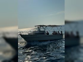 A lively group enjoys a day on the water aboard a boat, capturing the essence of adventure and camaraderie under the sun.