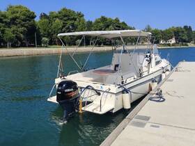 A motorboat docked at a serene marina, showcasing its sleek design and ready for a day on the water.