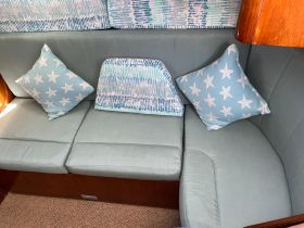 Cozy seating area inside the boat, featuring starfish-patterned cushions and a comfortable layout, perfect for relaxing during your nautical adventures.