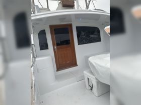 Interior view of a boat's helm area, showcasing the clean and functional design, perfect for a day out on the water.