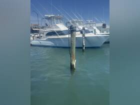 A sleek yacht docked at the marina, showcasing its elegant design and fishing gear, perfect for a day on the water.