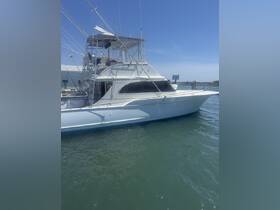 A sleek yacht docked in calm waters, showcasing its elegant design and fishing equipment — perfect for a day out on the sea.