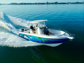 A couple enjoys a thrilling ride on a speedboat, cutting through calm waters — perfect for adventure seekers and water enthusiasts.