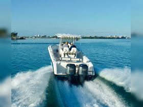 A speedboat glides through clear waters with passengers enjoying the ride, showcasing the thrill of boating adventures.