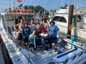 A lively group of friends celebrates aboard a fishing charter, showcasing camaraderie and excitement for a day on the water.