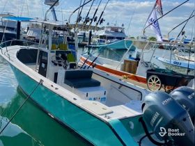 A vibrant speedboat docked at the marina, showcasing its sleek design and fishing gear, perfect for adventurous outings on the water.