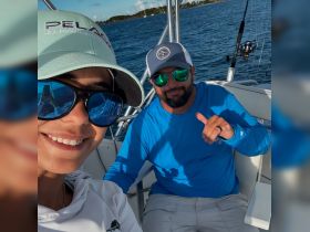 A cheerful selfie of two individuals aboard a boat, showcasing a fun day on the water. Perfect for capturing memorable moments during fishing or leisure trips.