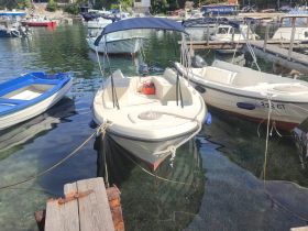 A serene view of a boat docked in a calm marina, surrounded by other vessels, showcasing the tranquil boating lifestyle.