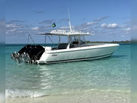 A sleek speedboat named 'Intrepid' docked in crystal-clear waters, showcasing its powerful engines and inviting design — perfect for thrilling adventures on the water.