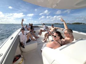 A lively group enjoys a sunny day on the water, celebrating and having fun aboard a boat — perfect for memorable outings with friends.