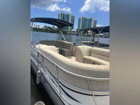 Interior view of a spacious pontoon boat featuring comfortable seating, perfect for relaxing on the water.