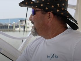 A man enjoys a moment on a boat, showcasing a relaxed atmosphere while navigating the waters. Perfect for capturing the essence of boating adventures.
