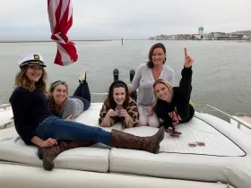 A lively group of friends enjoys their time aboard a boat, showcasing camaraderie and fun on the water.
