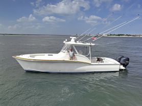 A sleek speedboat cruising through calm waters, showcasing its elegant design and fishing gear — perfect for a day on the water.