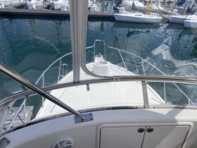 View of the helm area inside a boat, showcasing the sleek design and functionality of the cabin space, perfect for navigating the waters.