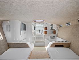 A spacious and well-appointed cabin interior of a boat, featuring comfortable seating and modern amenities, perfect for relaxing during a day on the water.
