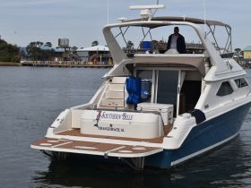 The Southern Belle yacht is docked, showcasing its elegant design and features, perfect for exploring the waters of Orange Beach, Alabama.