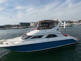 A sleek yacht docked in a marina, showcasing its elegant design and spacious layout, perfect for luxury outings on the water.