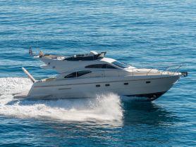 A stunning yacht glides through crystal-clear waters, showcasing its elegant design and smooth sailing capabilities.