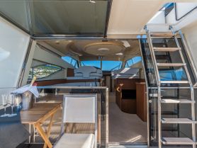A beautifully designed interior of a yacht showcasing the cabin and seating area, perfect for relaxing and enjoying the views while on the water.