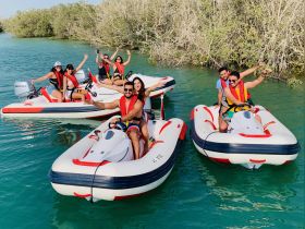 A lively group enjoys a day of jet skiing in the mangroves, showcasing fun and adventure on the water.