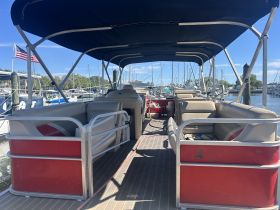 Interior view of a pontoon boat showcasing comfortable seating arrangements, perfect for relaxing on the water.