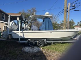 A side view of a boat docked on a trailer, showcasing its sleek design and features, perfect for fishing or leisure activities.