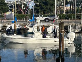 A group of individuals aboard a boat at the marina, preparing for a fishing adventure. The vibrant setting captures the excitement of a day on the water.