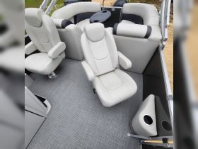 Interior view of a stylish boat cabin featuring comfortable seating and a sleek design, perfect for relaxing on the water.