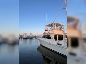 A stunning view of a yacht docked at the marina, showcasing its elegant design against a clear blue sky — perfect for boating enthusiasts and charters.