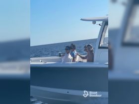 A group of friends enjoys a day out on the water, capturing moments aboard their boat — perfect for social gatherings and fun on the sea.