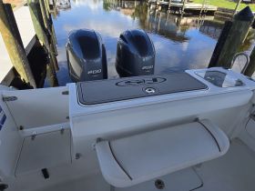 A clean and modern interior view of a boat's helm and seating area, showcasing the sleek design and functionality ideal for a day on the water.