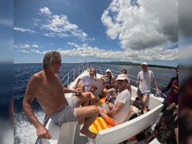 A lively group enjoys a day on the water aboard a boat, capturing the essence of fun and camaraderie under the sun.