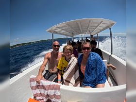 A joyful family enjoys a boat ride on the ocean, capturing the essence of fun and adventure on the water.