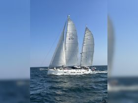 A beautiful sailboat glides through the water under full sail, showcasing its elegant design and perfect for sailing enthusiasts.
