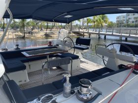 Interior view of a spacious yacht cabin featuring comfortable seating and a well-equipped helm, perfect for relaxing and navigating on the water.